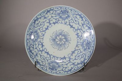 a blue and white plate with a flower design on it