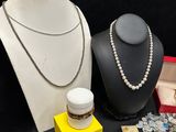 a lot of jewelry on display on a black table