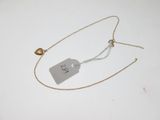 necklace with a tag attached to it on a white surface