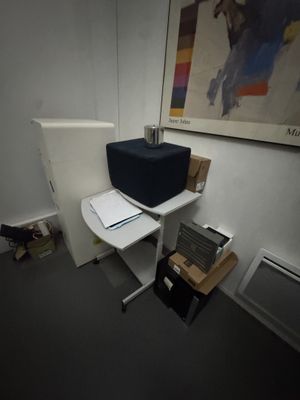 a desk with a computer and a printer on it