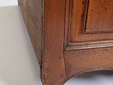 a wooden cabinet with a drawer on top of it