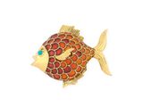 an image of a gold and red fish broochle on a white background