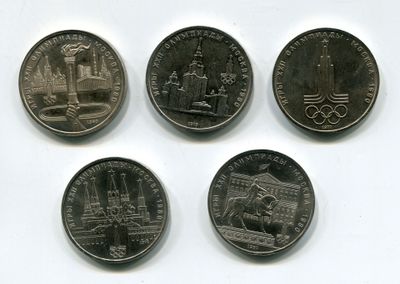four different types of coins are shown on a white surface