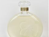 an image of a bottle of perfume sitting on a white surface