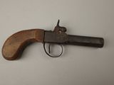 a close up of an old gun on a white surface