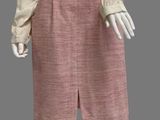 an image of a mannequin wearing a pink skirt and white shirt