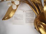 a gold plate with flowers and a book on it