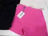 two women ' s shorts with tags on them sitting on a table