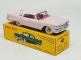 pink toy car sitting on top of a box on a white surface