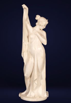 a white marble statue of a woman holding a flag
