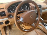 the interior of a car with a steering wheel and dashboard controls