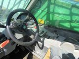a steering wheel of a tractor with a green screen in the background