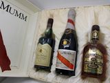 three bottles of liquor in a box on a table