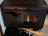 a black oven sitting on top of a black counter
