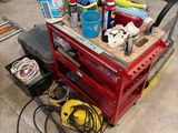 a red work bench with tools on it in a garage