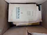 a box with a book inside of it sitting on the floor