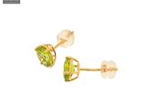 a close up of a pair of earrings with a green stone