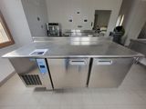 stainless steel counter top in a commercial kitchen with stainless steel appliances