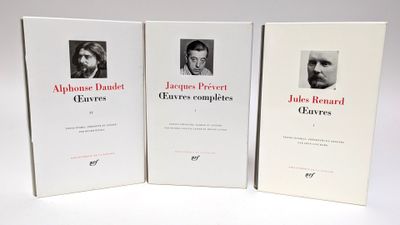 trois livres posés sur une table blanche, avec la photo d'un homme et d'une femme