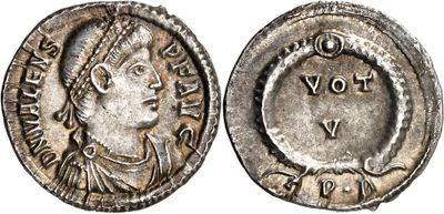 a silver coin with an image of a woman on it