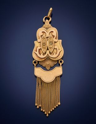 a gold pendant with a tassel hanging from it ' s side