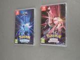 two nintendo wii games are sitting on a table next to each other