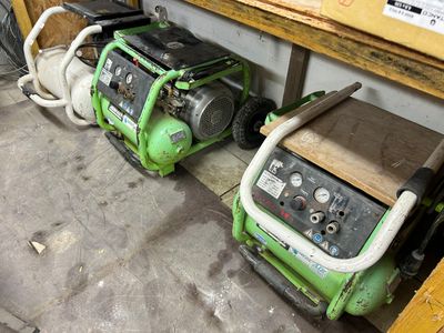 two generators sitting next to each other on the floor