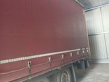 a red semi truck parked in a garage