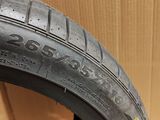 a close up of a tire on the floor with a cardboard box in the background