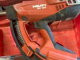 a cordless nail gun in a red toolbox
