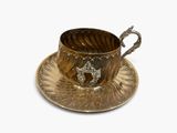 a cup and saucer on a saucer on a white surface