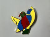 a colorful bird that is sitting on a white surface
