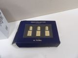 a box with three bottles of perfume sitting on top of a table