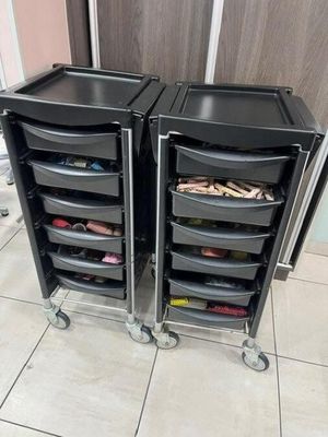 two black plastic drawers are stacked on top of each other