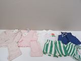 a pile of baby clothes sitting on a table