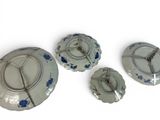 three plates with blue flowers on them on a white surface