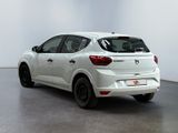 the rear end of a white car parked in a white room