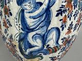 a blue and white vase with a child on it