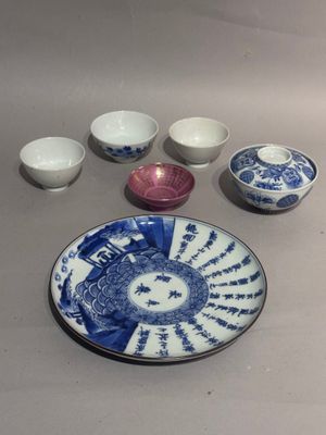 a blue and white plate and bowls on a table