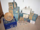 many boxes of wine glasses and a basket on the floor
