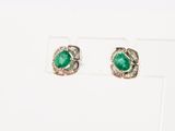 a pair of emerald and diamond earrings