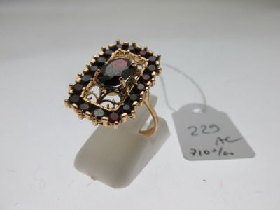 une photo d'une bague en or sertie de grenats, avec une étiquette de prix