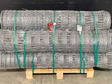 a pile of gal steel wire on pallets in a warehouse