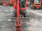 an image of a red forklift in a parking lot