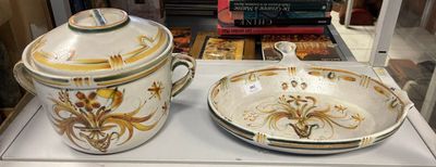 two bowls and a saucer on display in a glass case