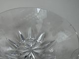 a clear glass bowl with a star design on it