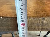 a measuring tape on a table with a chair in the background