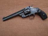 a close up of a revolver on a brown background