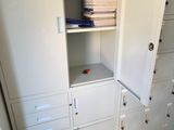 a white cabinet with a bunch of files in it