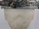 a light hanging from the ceiling with a planter on it
